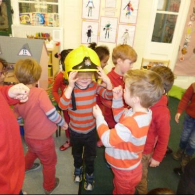 Trying on the fireman's helmet.
